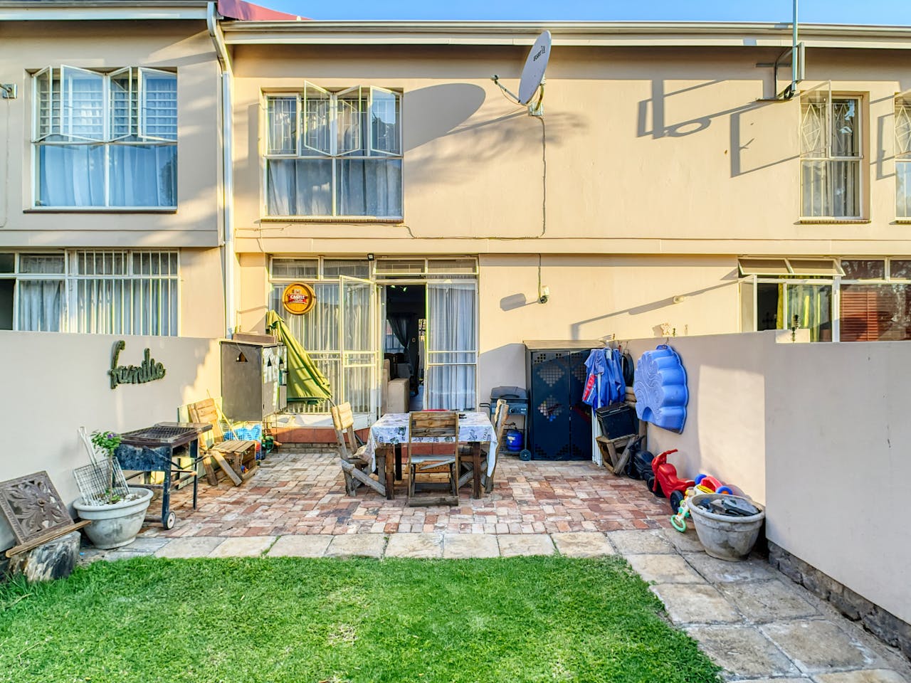 Charming suburban patio with garden, table, and chairs in Pretoria, South Africa.