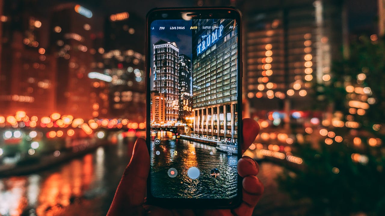 portfolio-04 A smartphone capturing the illuminated Chicago skyline at night with Trump Tower in focus.